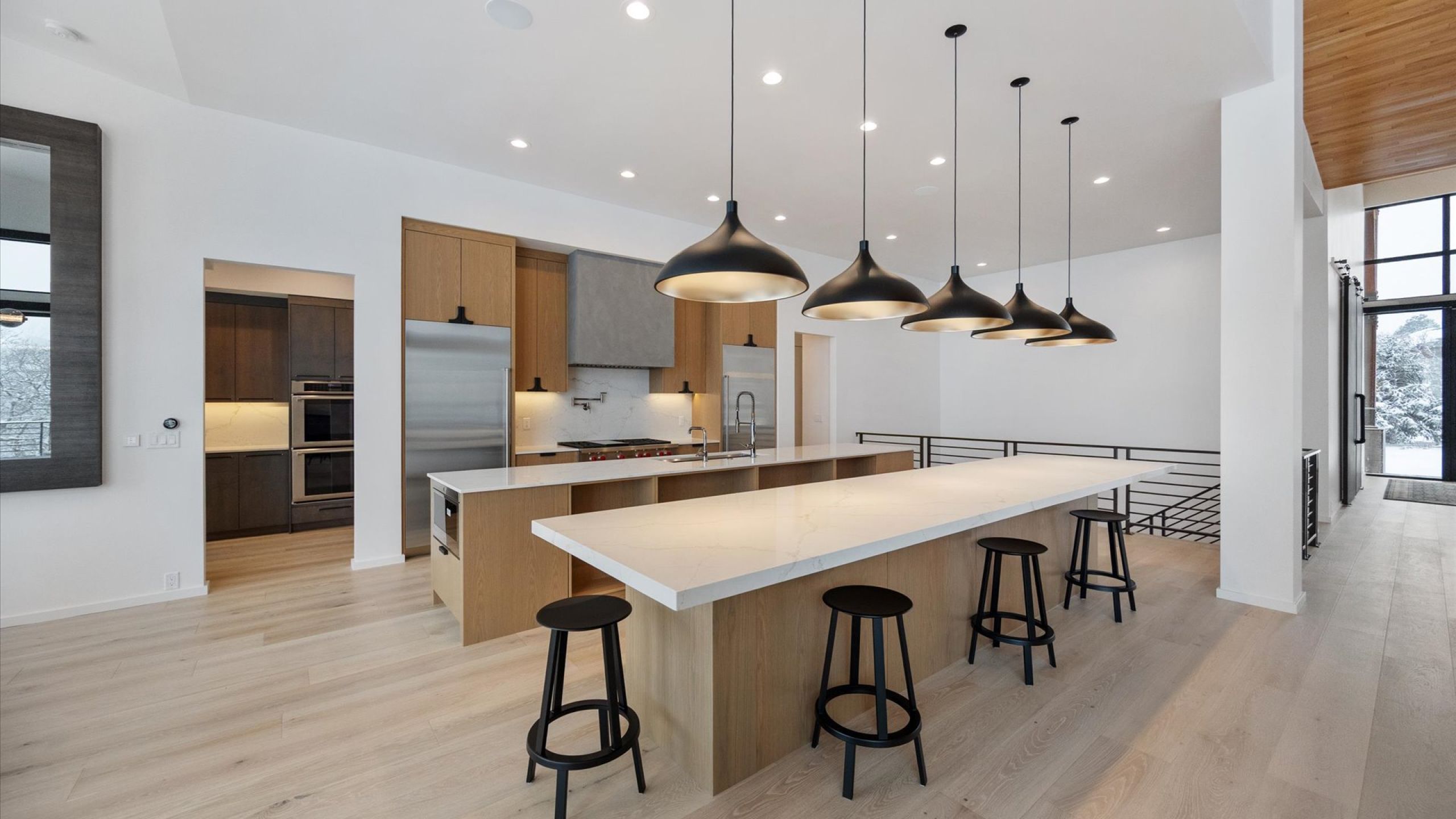 Kitchen featuring a kitchen bar, light wood-type flooring, stainless steel appliances, a kitchen island