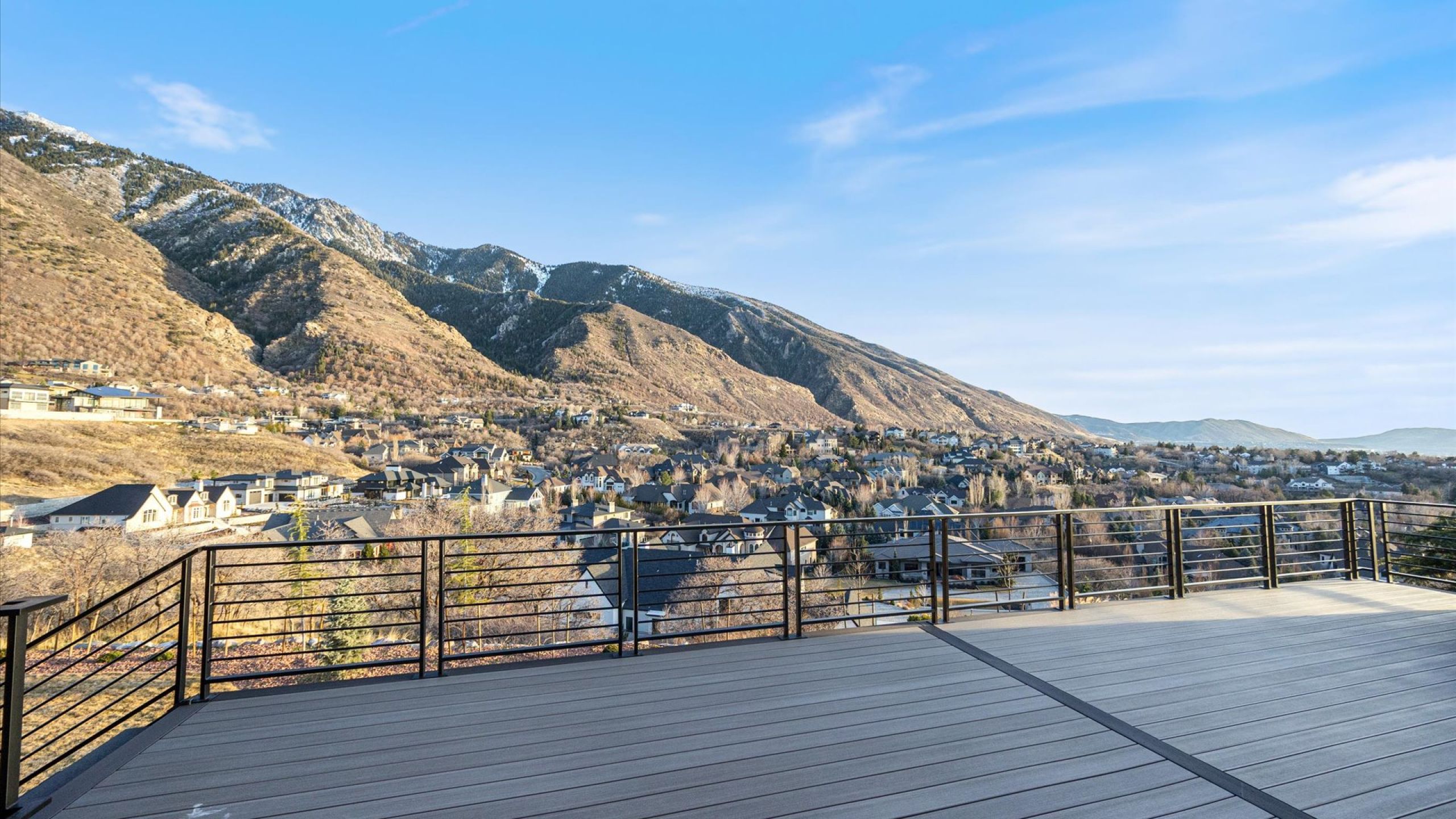 Deck with a mountain view and a residential view