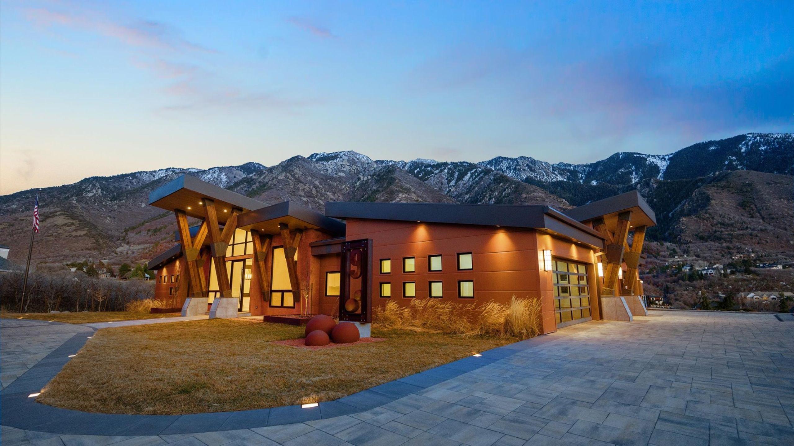 Modern home featuring a mountain view, driveway,  yard and garage